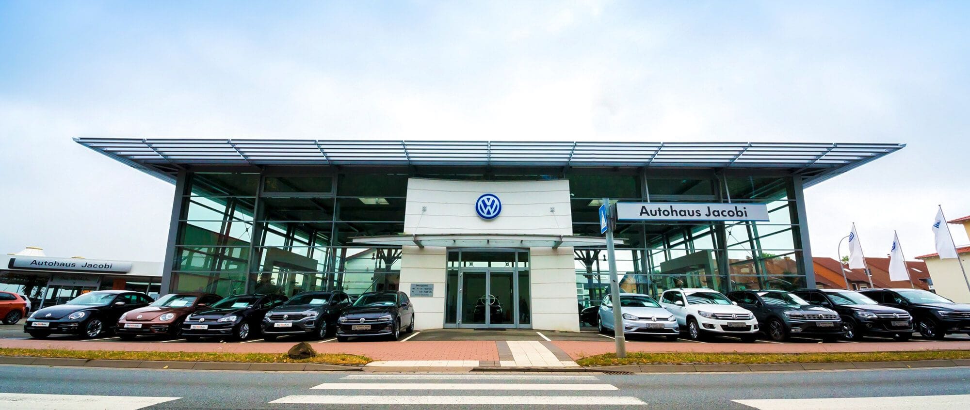 Volkswagen Autohaus mit großer Fahrzeugausstellung auf dem Vorplatz