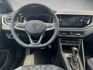 Lenkrad und Armaturenbrett eines modernen VW-Fahrzeugs, Schwarz, mit mehreren Bildschirmdisplays.