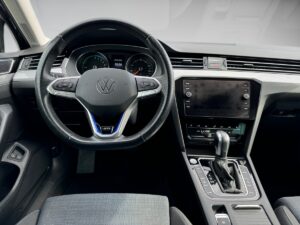 Volkswagen Innenraum mit Lenkrad, Armaturenbrett und Touchscreen in Schwarz und Grau.