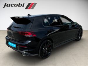 Schwarzer VW Golf GTI seitlich, steht auf hellem Boden. Logo "Jacobi" oben links sichtbar.