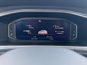 Digitales Auto-Cockpit mit Geschwindigkeits- und Kilometeranzeige in Blau und Schwarz.